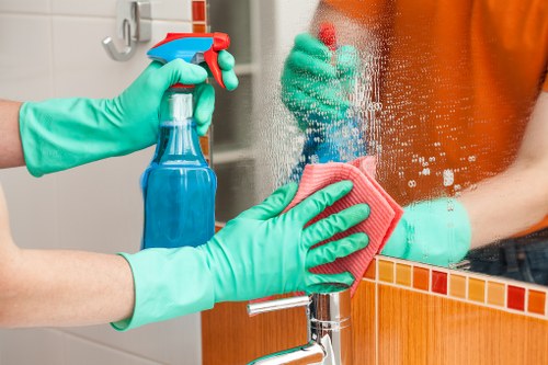 Cleaner preparing safe cleaning equipment and checking workspace hazards