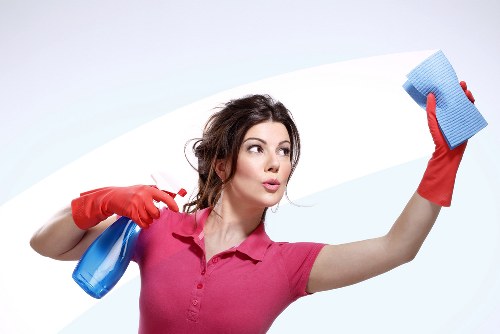 Local cleaner treating stains on a sofa in a Twickenham property